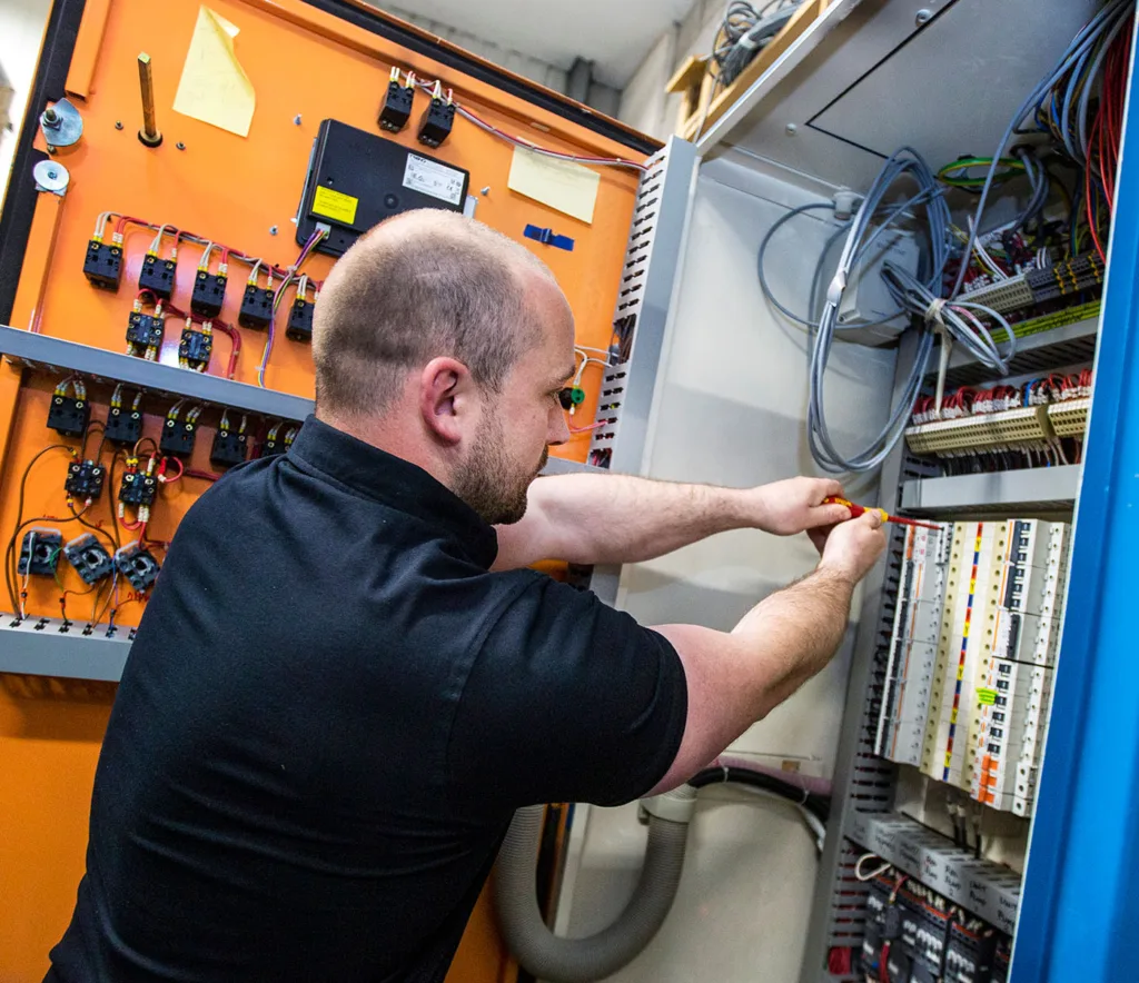 Why Now Is the Time to Plan Your 2026 CAPEX Projects this image shows one of our electricians working on a panel