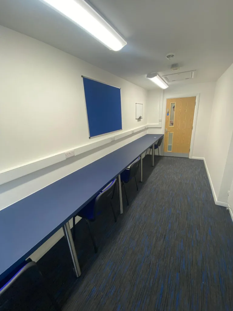 Staff office created from former store room at Slated Row School with fitted workspace and seating