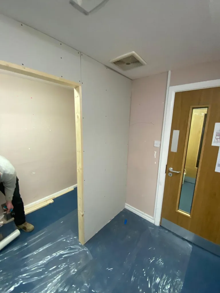 Breakout room construction at Slated Row School showing partition wall installation