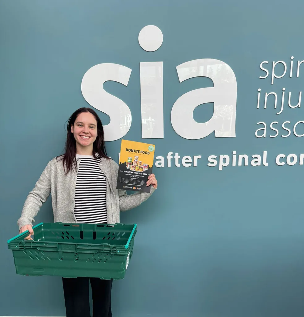 Spinal Injuries Association team supporting MK Food Bank campaign by hosting donation crate in Milton Keynes